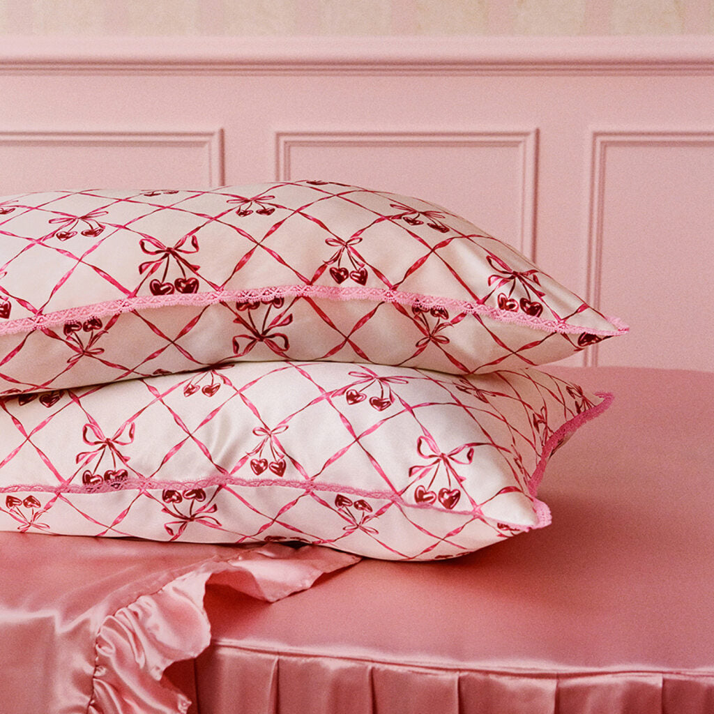 Silk pillowcase with pink bow pattern and on a white background